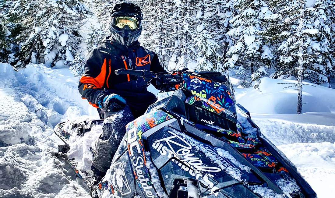 Cedrik Moreau ridding a snowmobile