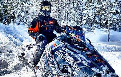 Cedrik Moreau ridding a snowmobile