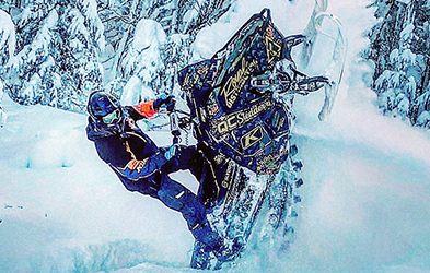 Cedrik Moreau ridding a snowmobile