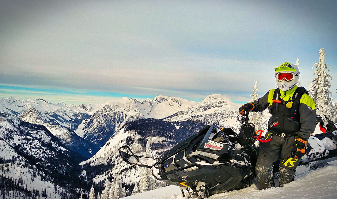 Kyle Smith riding a snowmobile