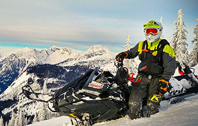 Kyle Smith riding a snowmobile