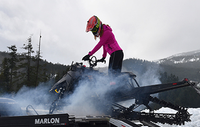 Brianna Cummin riding a Snowmobile