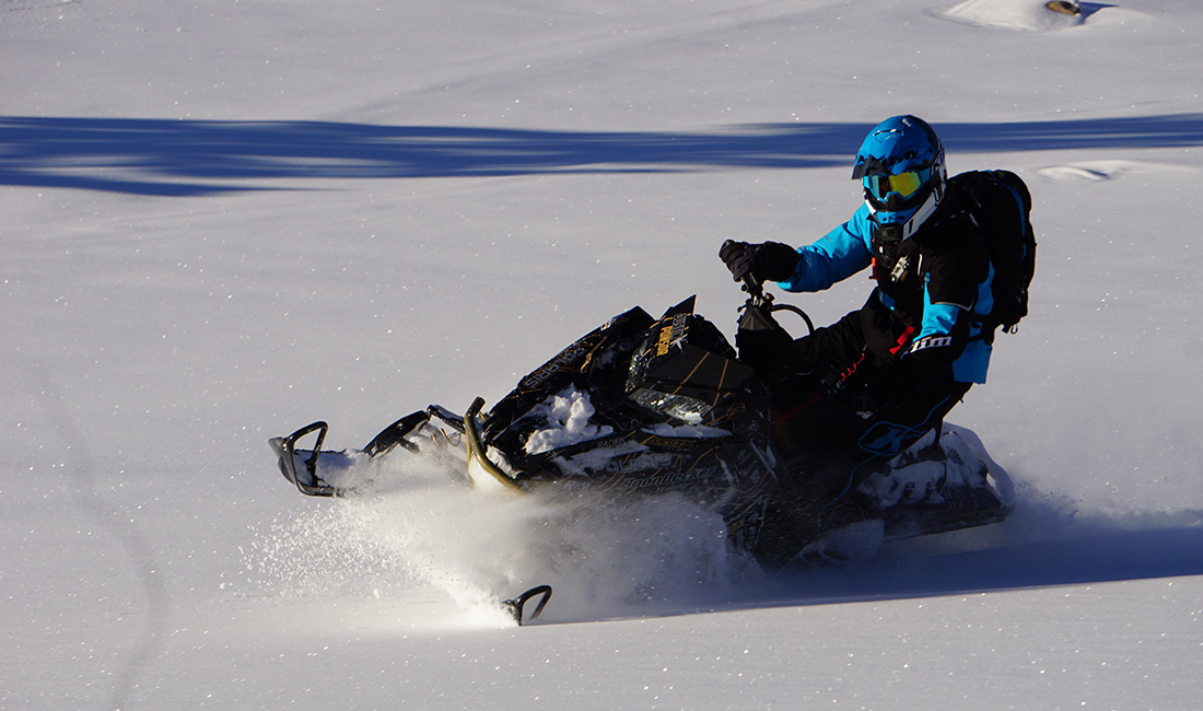Justin Ponsor riding a Snowmobile