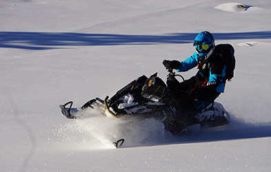 Justin Ponsor riding a Snowmobile