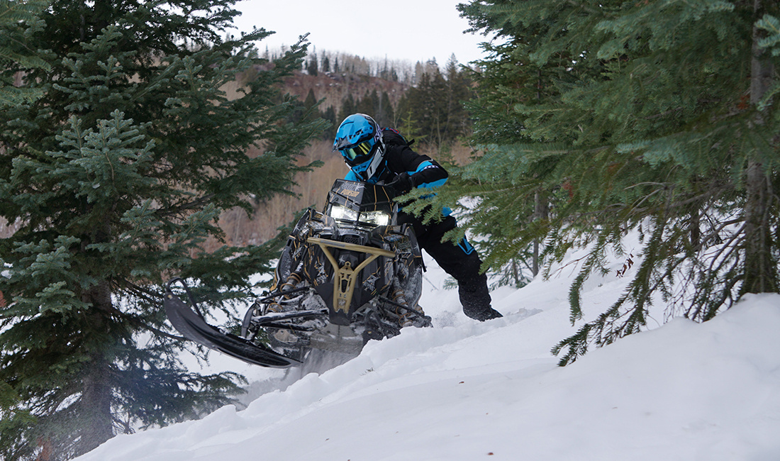 Justin Ponsor riding a Snowmobile
