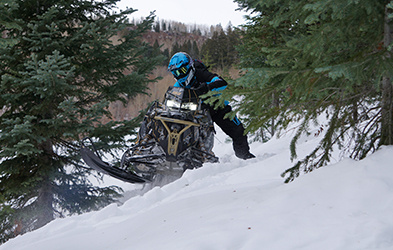 Justin Ponsor riding a Snowmobile