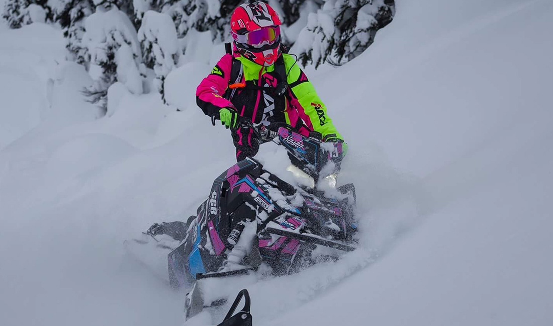 Sasha Bodie riding a snowmobile