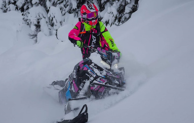 Sasha Bodie riding a snowmobile