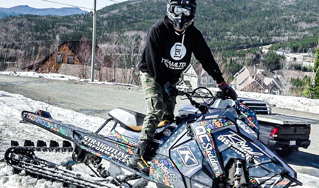 Cedrik Moreau ridding a snowmobile