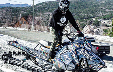 Cedrik Moreau ridding a snowmobile