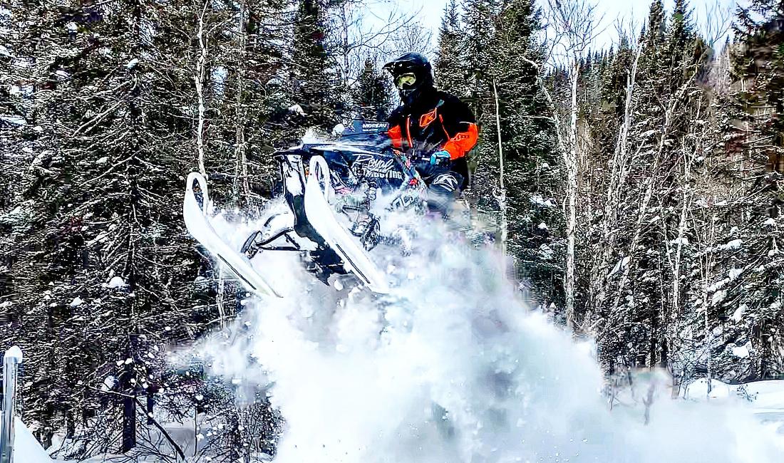Cedrik Moreau ridding a snowmobile