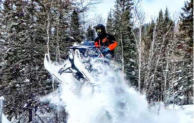 Cedrik Moreau ridding a snowmobile