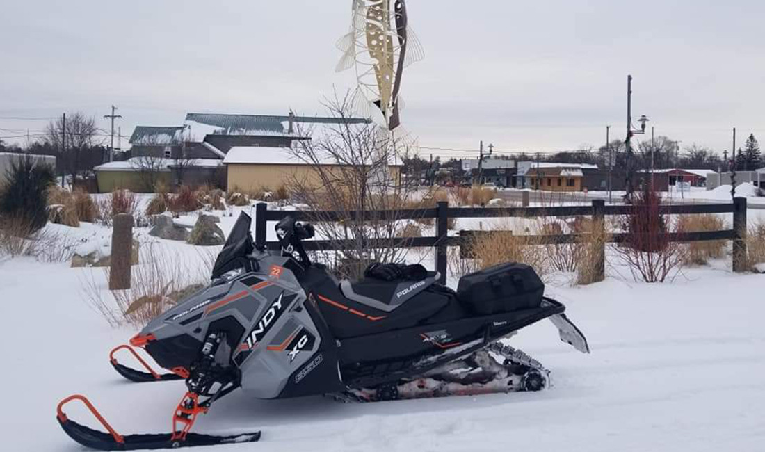 Michael Keith riding a Snowmobile