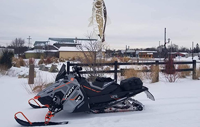 Michael Keith riding a Snowmobile