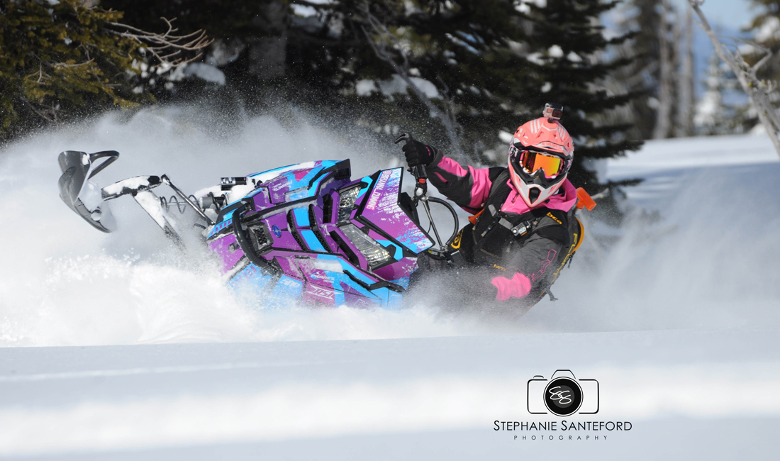 Brianna Cumming ridding a snowmobile