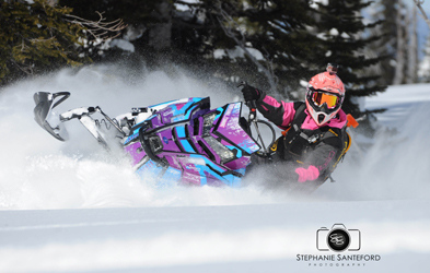 Brianna Cumming ridding a snowmobile