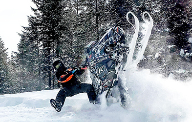 Cedrik Moreau ridding a snowmobile