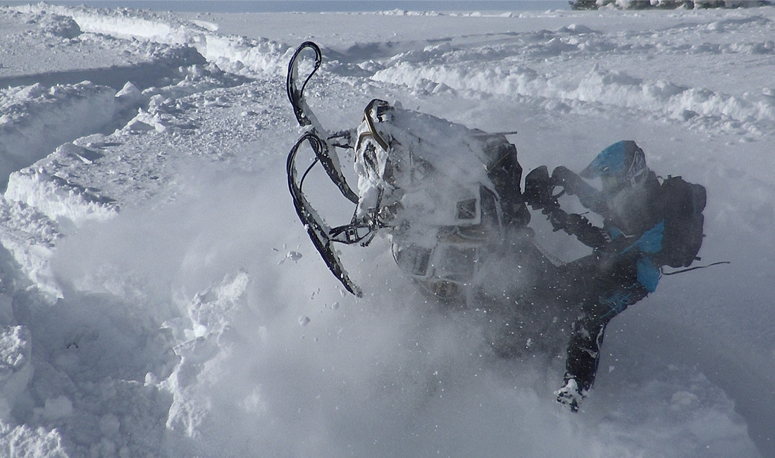 Justin Ponsor riding a Snowmobile
