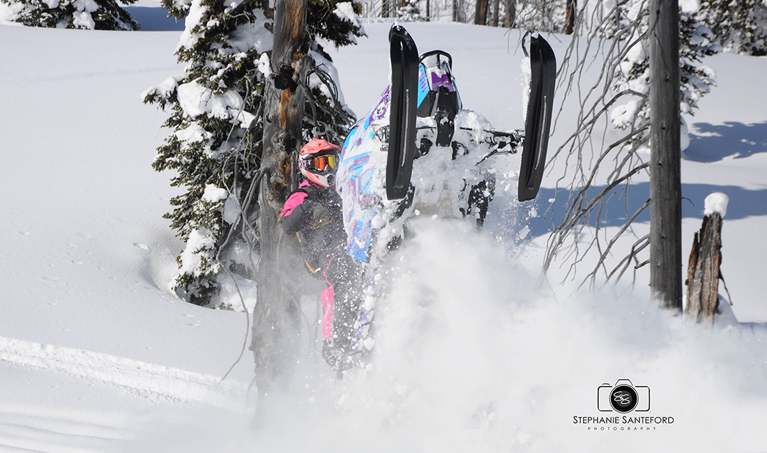 Brianna Cumming riding a snowmobile