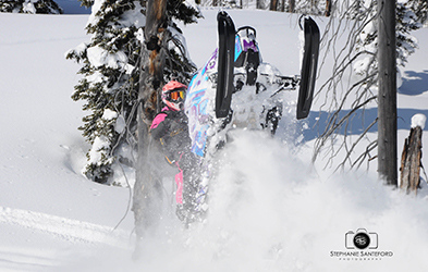 Brianna Cumming riding a snowmobile