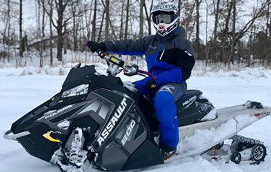 Tucker Trettel riding a Snowmobile