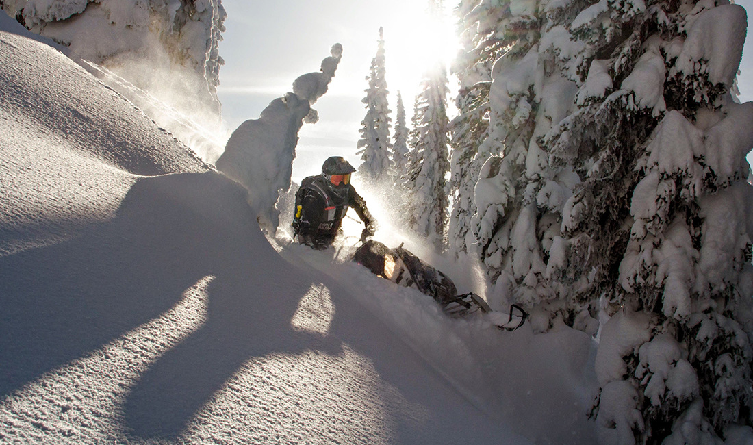 Kyle Smith riding a snowmobile