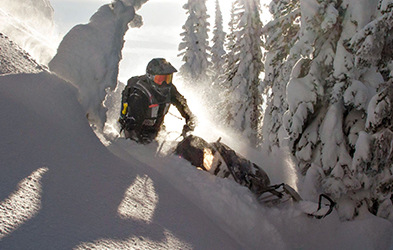 Kyle Smith riding a snowmobile