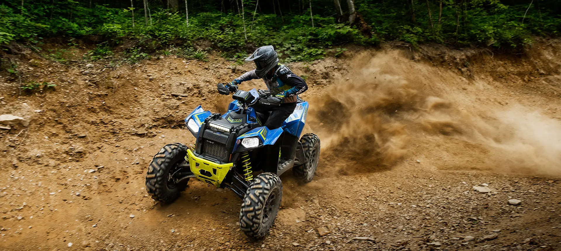 A Scrambler 850 rider racing on a trail road