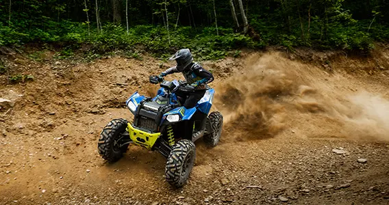 A Scrambler 850 rider racing on a trail road