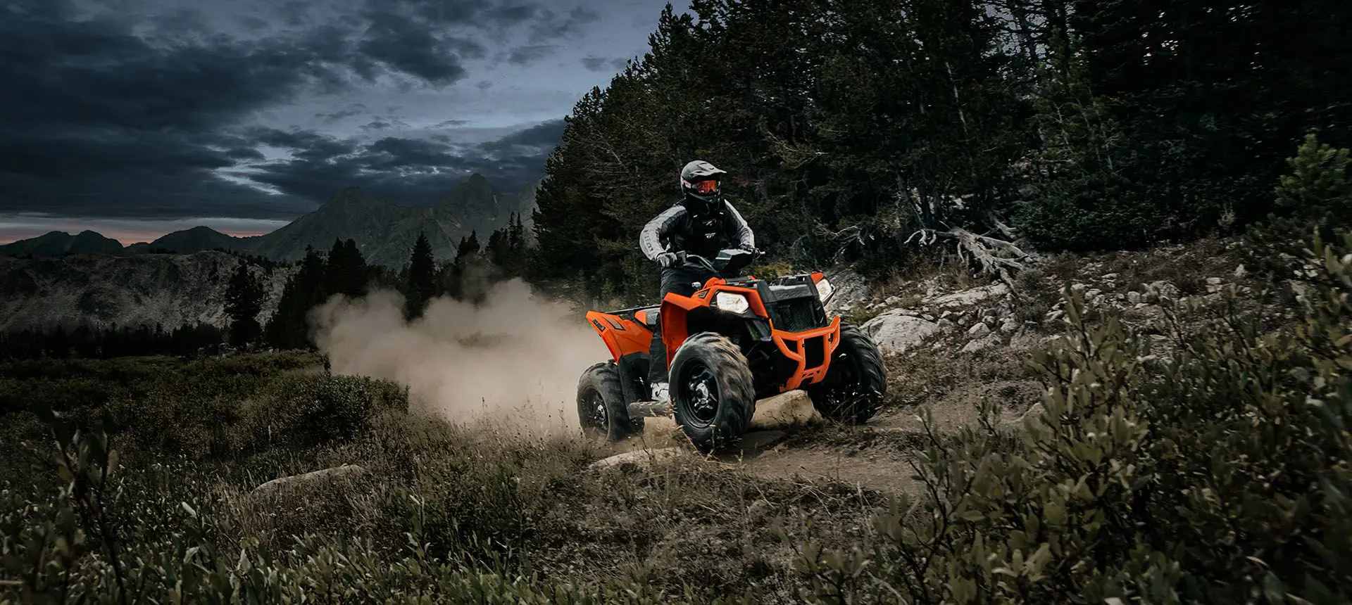 Rider climbing a steep hill with his Polaris Scrambler 850