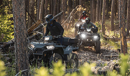  2 polaris sportsman 450's trail riding with all-wheel drive