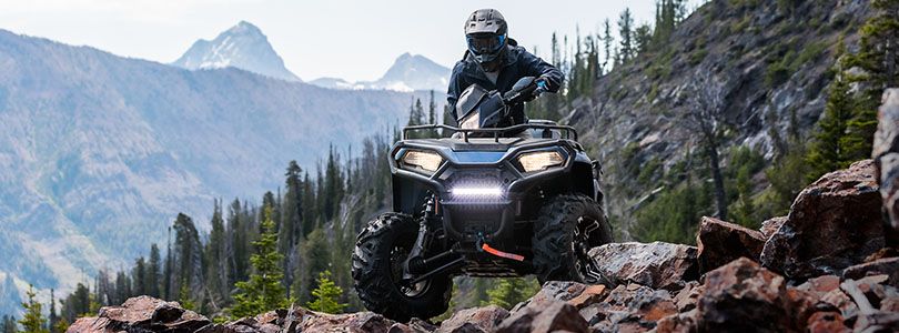 RZR 570 going down a green trail road