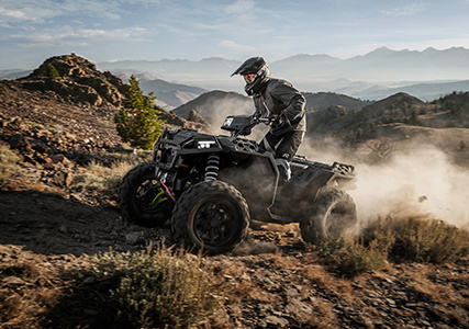 man showcasing the stronger chasis on his sportsman xp 1000 S by riding through tough terrain