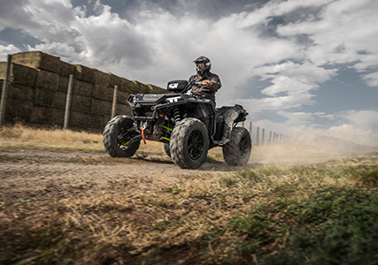 man showcasing the stronger front differential on his sportsman xp 1000 S by riding down a tough trail