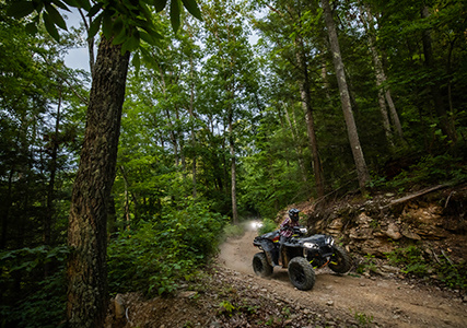 Rider utilizing the 14 inch long travel suspension on his Sportsman XP 1000 S 