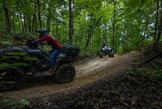 RZR 570 going down a green trail road