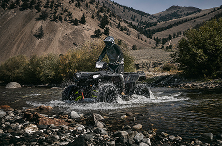 Sportsman XP 1000 s powering through a stream with unmatched capability