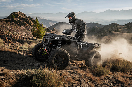 Sportsman XP 1000 s swiftly riding uphill over rocky terrain