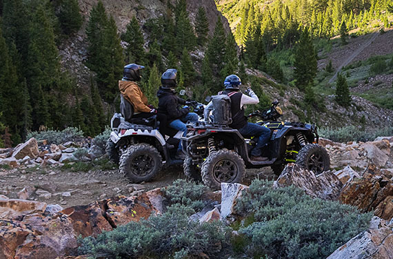 RZR 570 going down a green trail road
