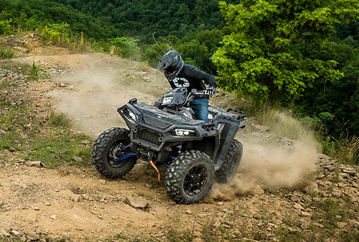 RZR 570 going down a green trail road