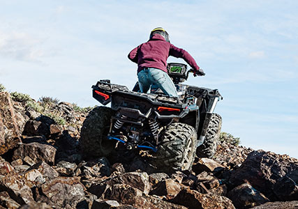 sportsman xp 1000 easily climbing rocks with power steering and 27 inch tires