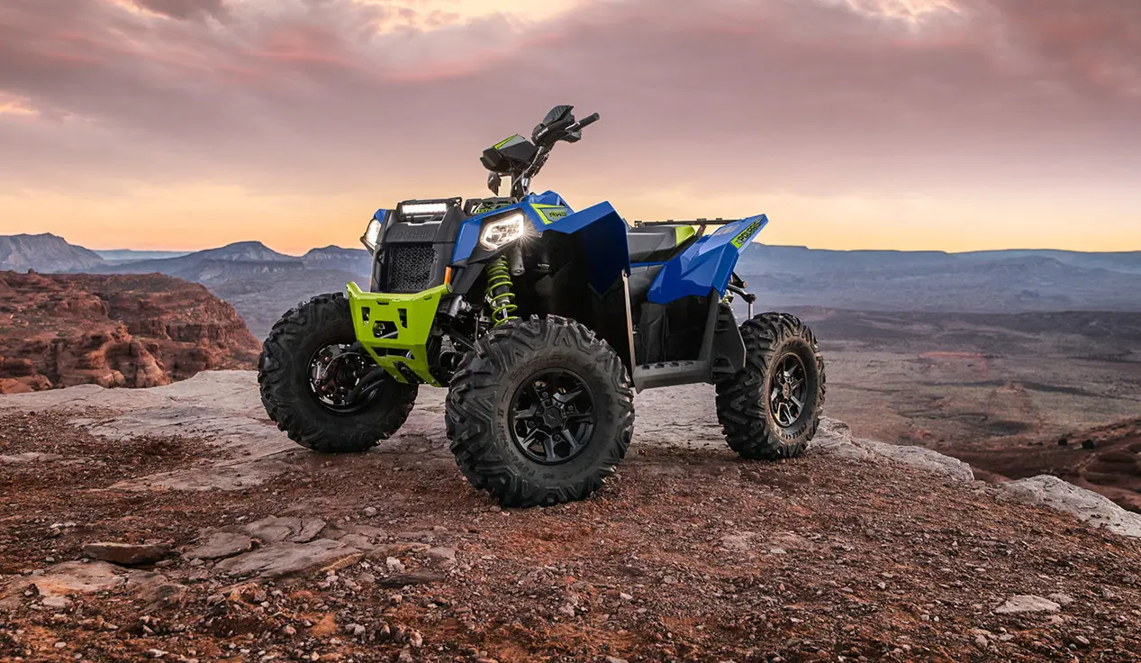 polaris scrambler xp 1000 s in radar blue on a cliff