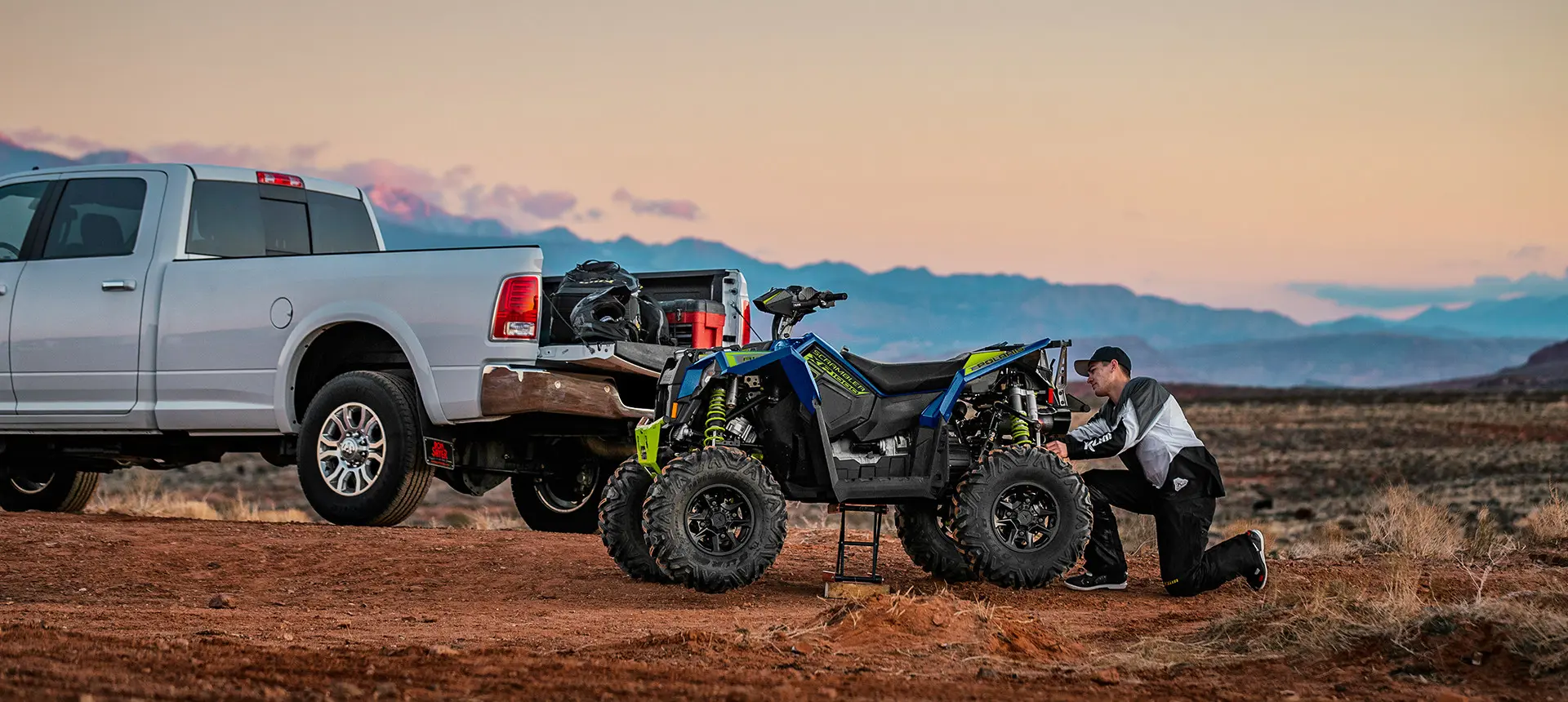 man adjusting the suspension on his radar blue scrambler xp 1000 s atv