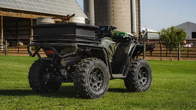 sportsman 450 utility atv parked on a farm