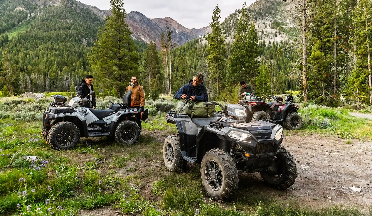 homme attachant de l’équipement à l’arrière de son vtt Sportsman 850