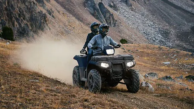 Deux conducteurs dévalent sentier poussiéreux sur leur polaris sportsman touring 850