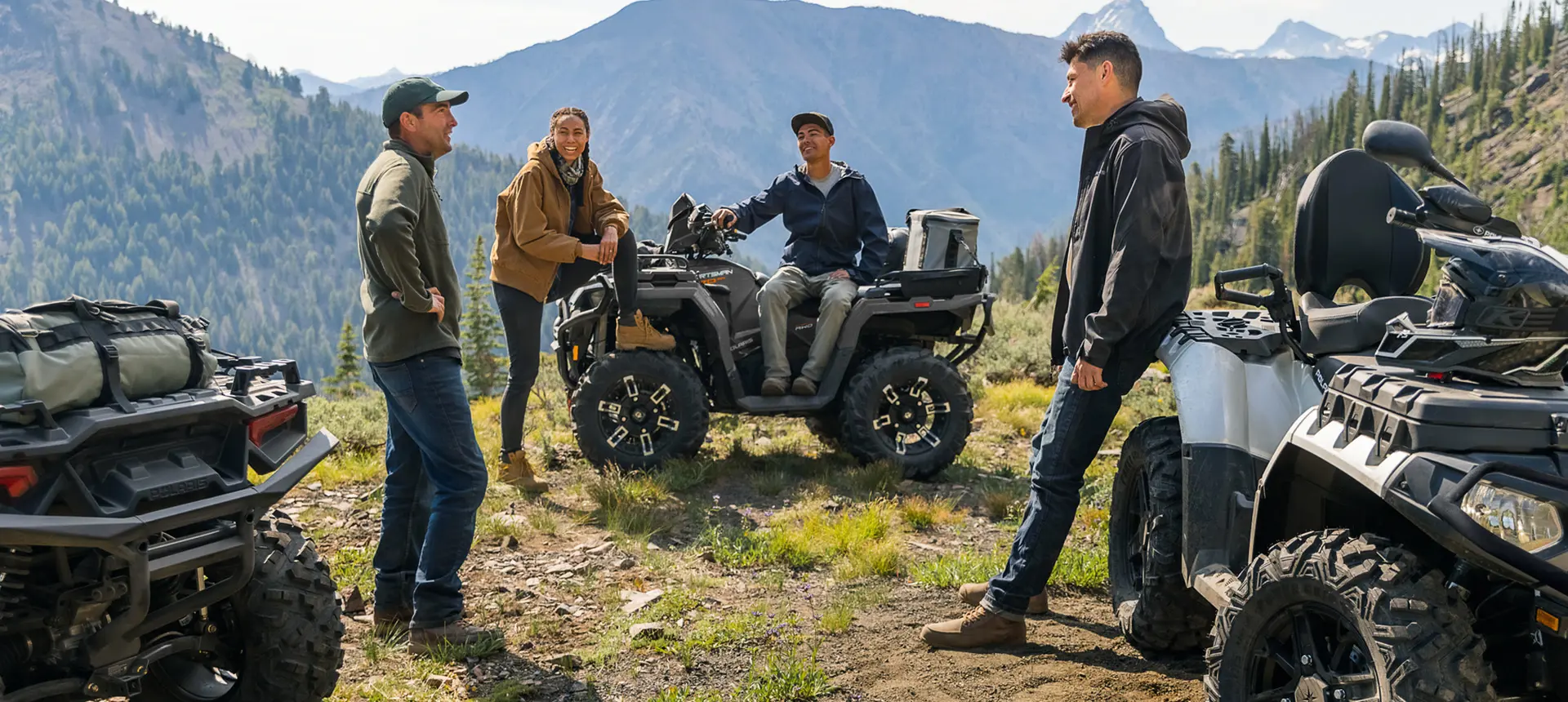 friends relaxing after a ride on their sportsman atvs