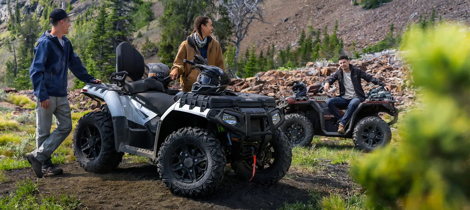 couple relaxing after a ride on their Sportsman Touring XP 1000 trail atv