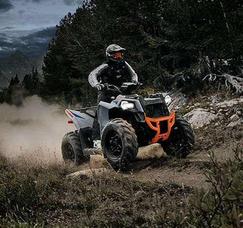 A rider on the nimble, 48-inch wide 2025 Polaris Scrambler 850 sport ATV.