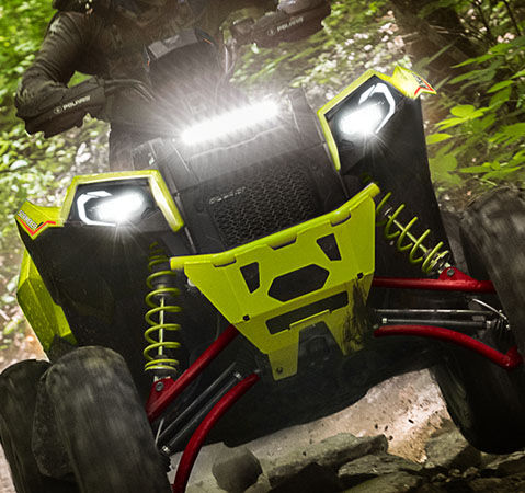 Front view of a 2025 Polaris Scrambler XP 1000 S Sport ATV showcasing the new steerable pod and LED headlights. 